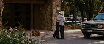 Movie still from “Crazy Heart” (2009), directed by Scott Cooper – A man and a woman hugging on the sidewalk; Wide shot, Over the shoulder angle