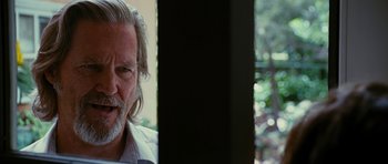 Movie still from “Crazy Heart” (2009), directed by Scott Cooper – An older man with long white hair and a gray beard; Close Up shot, Over the shoulder angle