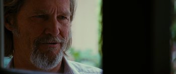 Movie still from “Crazy Heart” (2009), directed by Scott Cooper – An older man with a beard looking at a computer screen; Close Up shot, Over the shoulder angle