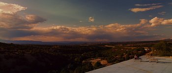 Movie still from “Crazy Heart” (2009), directed by Scott Cooper – A view of a mountain range with a cloudy sky in the background; Extreme Wide shot, Low angle