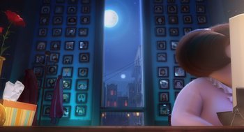 Movie still from “Despicable Me” (2010), directed by Pierre Coffin – A person sitting in front of a window at night; Medium shot, Over the shoulder angle