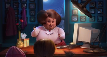 Movie still from “Despicable Me” (2010), directed by Pierre Coffin – An animated woman sitting at a desk in front of a computer; Wide shot, Over the shoulder angle