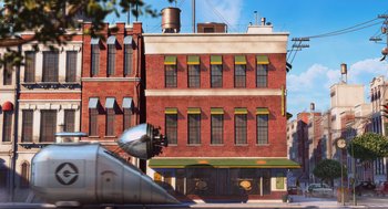 Movie still from “Despicable Me” (2010), directed by Pierre Coffin – An airplane is parked in front of a building; Extreme Wide shot, Low angle