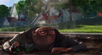 Movie still from “Despicable Me” (2010), directed by Pierre Coffin – An image of an animated character laying on the ground; Wide shot, Low angle