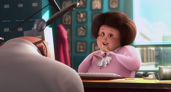 Movie still from “Despicable Me” (2010), directed by Pierre Coffin – An animated woman is sitting at a desk; Medium shot, Over the shoulder angle