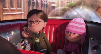 Movie still from “Despicable Me” (2010), directed by Pierre Coffin – A group of people sitting on a red car; Medium shot, Over the shoulder angle