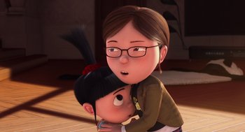 Movie still from “Despicable Me” (2010), directed by Pierre Coffin – An animated woman hugging a small child; Close Up shot, Over the shoulder angle