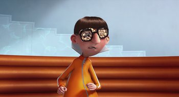 Movie still from “Despicable Me” (2010), directed by Pierre Coffin – A cartoon of a person wearing glasses and an orange outfit; Medium shot, Over the shoulder angle