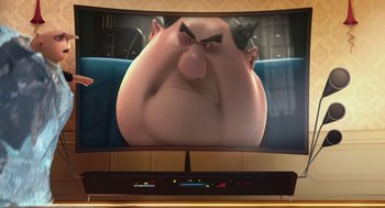 Movie still from “Despicable Me” (2010), directed by Pierre Coffin – A television screen with a large picture of an overweight man; Extreme Close Up shot, Over the shoulder angle
