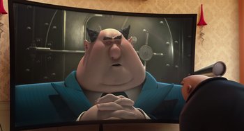 Movie still from “Despicable Me” (2010), directed by Pierre Coffin – A man in a blue suit and a black hat is looking at a picture of a man in a blue suit and a black hat; Medium shot, Over the shoulder angle