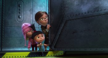 Movie still from “Despicable Me” (2010), directed by Pierre Coffin – A group of people standing next to each other near a wall; Wide shot, Over the shoulder angle
