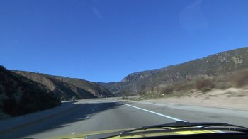 Movie still from “Creep” (2014), directed by Patrick Brice – A view from a car of a mountain road; Extreme Wide shot, High angle