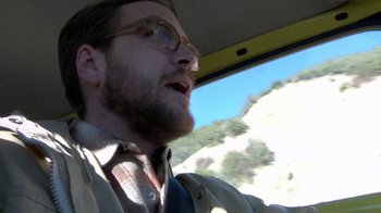 Movie still from “Creep” (2014), directed by Patrick Brice – A man with a goatee driving a car; Close Up shot, Low angle