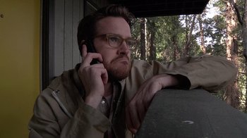 Movie still from “Creep” (2014), directed by Patrick Brice – A man with a beard is talking on a cell phone; Close Up shot, Low angle