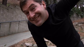 Movie still from “Creep” (2014), directed by Patrick Brice – A person wearing a black shirt; Close Up shot, Overhead angle