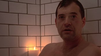 Movie still from “Creep” (2014), directed by Patrick Brice – A man in a bathroom with a candle in front of him; Close Up shot, Over the shoulder angle