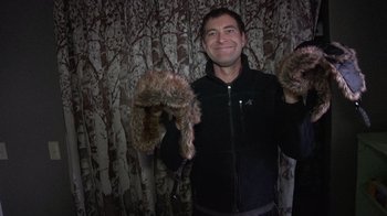 Movie still from “Creep” (2014), directed by Patrick Brice – A man holding a pair of furry mittens; Close Up shot, Low angle