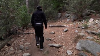 Movie still from “Creep” (2014), directed by Patrick Brice – A man walking on a trail in the woods; Wide shot, Low angle