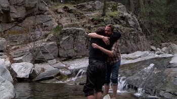 Movie still from “Creep” (2014), directed by Patrick Brice – A couple of people that are hugging in the water; Wide shot, Over the shoulder angle