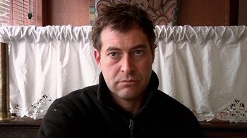 Movie still from “Creep” (2014), directed by Patrick Brice – A person wearing a black jacket; Close Up shot, Low angle