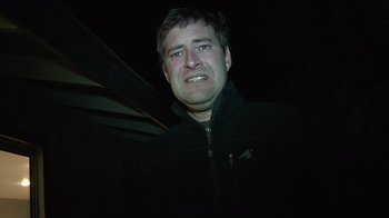 Movie still from “Creep” (2014), directed by Patrick Brice – A person wearing a black jacket; Close Up shot, Low angle
