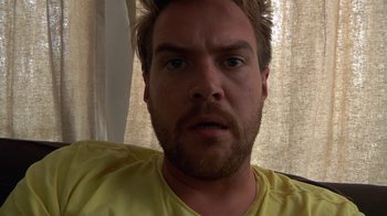 Movie still from “Creep” (2014), directed by Patrick Brice – A person wearing a yellow shirt; Close Up shot, High angle