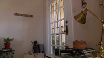 Movie still from “Creep” (2014), directed by Patrick Brice – A room with a door open to a room with an open window; Wide shot, High angle