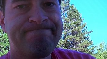 Movie still from “Creep” (2014), directed by Patrick Brice – A man's face with trees in the background; Close Up shot, Low angle