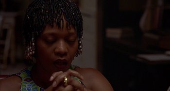Movie still from “Crooklyn” (1994), directed by Spike Lee – A person with their hands clasped together; Close Up shot, Low angle