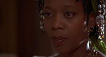Movie still from “Crooklyn” (1994), directed by Spike Lee – A woman's face in a dark room; Close Up shot, Low angle