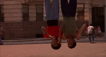 Movie still from “Crooklyn” (1994), directed by Spike Lee – Two young men hanging upside down in the street; Medium shot, Low angle
