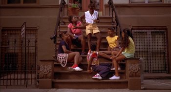 Movie still from “Crooklyn” (1994), directed by Spike Lee – A group of young people sitting on a set of stairs; Wide shot, High angle