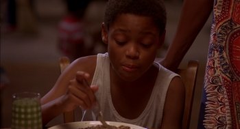Movie still from “Crooklyn” (1994), directed by Spike Lee – A young boy is eating food from a plate; Close Up shot, High angle