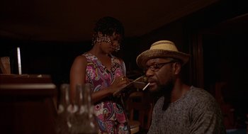 Movie still from “Crooklyn” (1994), directed by Spike Lee – A man and a woman are smoking a cigarette together; Medium shot, Low angle