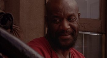 Movie still from “Crooklyn” (1994), directed by Spike Lee – A person wearing a red shirt; Close Up shot, Low angle