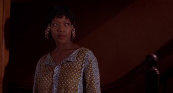 Movie still from “Crooklyn” (1994), directed by Spike Lee – A woman in a yellow and blue shirt is looking at the camera; Close Up shot, Low angle
