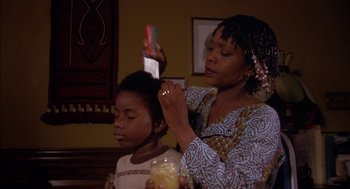 Movie still from “Crooklyn” (1994), directed by Spike Lee – A woman and a child are combing their hair; Medium shot, Low angle