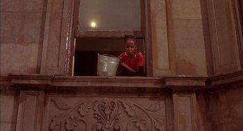 Movie still from “Crooklyn” (1994), directed by Spike Lee – A little girl looking out of a window at night; Medium shot, Low angle