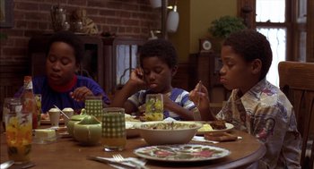 Movie still from “Crooklyn” (1994), directed by Spike Lee – A group of children sitting at a table eating food; Medium shot, High angle