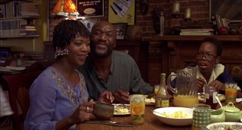Movie still from “Crooklyn” (1994), directed by Spike Lee – A man and a woman sitting at a dinner table; Medium shot, Low angle