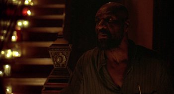 Movie still from “Crooklyn” (1994), directed by Spike Lee – A man sitting in front of a stair case; Close Up shot, Over the shoulder angle