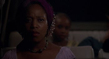 Movie still from “Crooklyn” (1994), directed by Spike Lee – A person wearing a purple headscarf; Close Up shot, Low angle