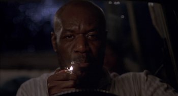 Movie still from “Crooklyn” (1994), directed by Spike Lee – A person holding a cigarette in his mouth; Close Up shot, Low angle