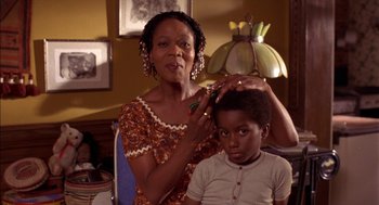 Movie still from “Crooklyn” (1994), directed by Spike Lee – A woman and a boy are combing each others hair; Close Up shot, Low angle