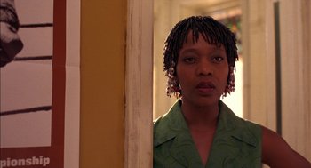 Movie still from “Crooklyn” (1994), directed by Spike Lee – A woman standing in front of a mirror; Close Up shot, Low angle