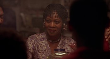 Movie still from “Crooklyn” (1994), directed by Spike Lee – A woman sitting at a table with a cup of coffee; Close Up shot, Over the shoulder angle
