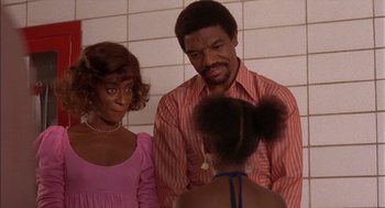 Movie still from “Crooklyn” (1994), directed by Spike Lee – A man and a woman talking to a young girl; Medium shot, High angle