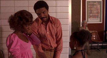 Movie still from “Crooklyn” (1994), directed by Spike Lee – A man and a woman standing next to each other in a bathroom; Medium shot, Over the shoulder angle