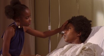 Movie still from “Crooklyn” (1994), directed by Spike Lee – A young girl is touching the head of a young woman; Close Up shot, Over the shoulder angle