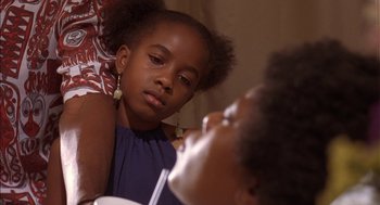 Movie still from “Crooklyn” (1994), directed by Spike Lee – A young girl sitting in front of another young girl; Close Up shot, Over the shoulder angle